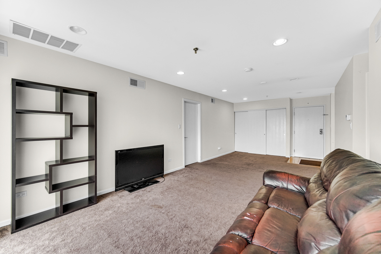 3255 Kirchoff Road, Unit 312 Rolling Meadows, IL 60008 - Photo 6 of 22 a living room with a couch and a fireplace