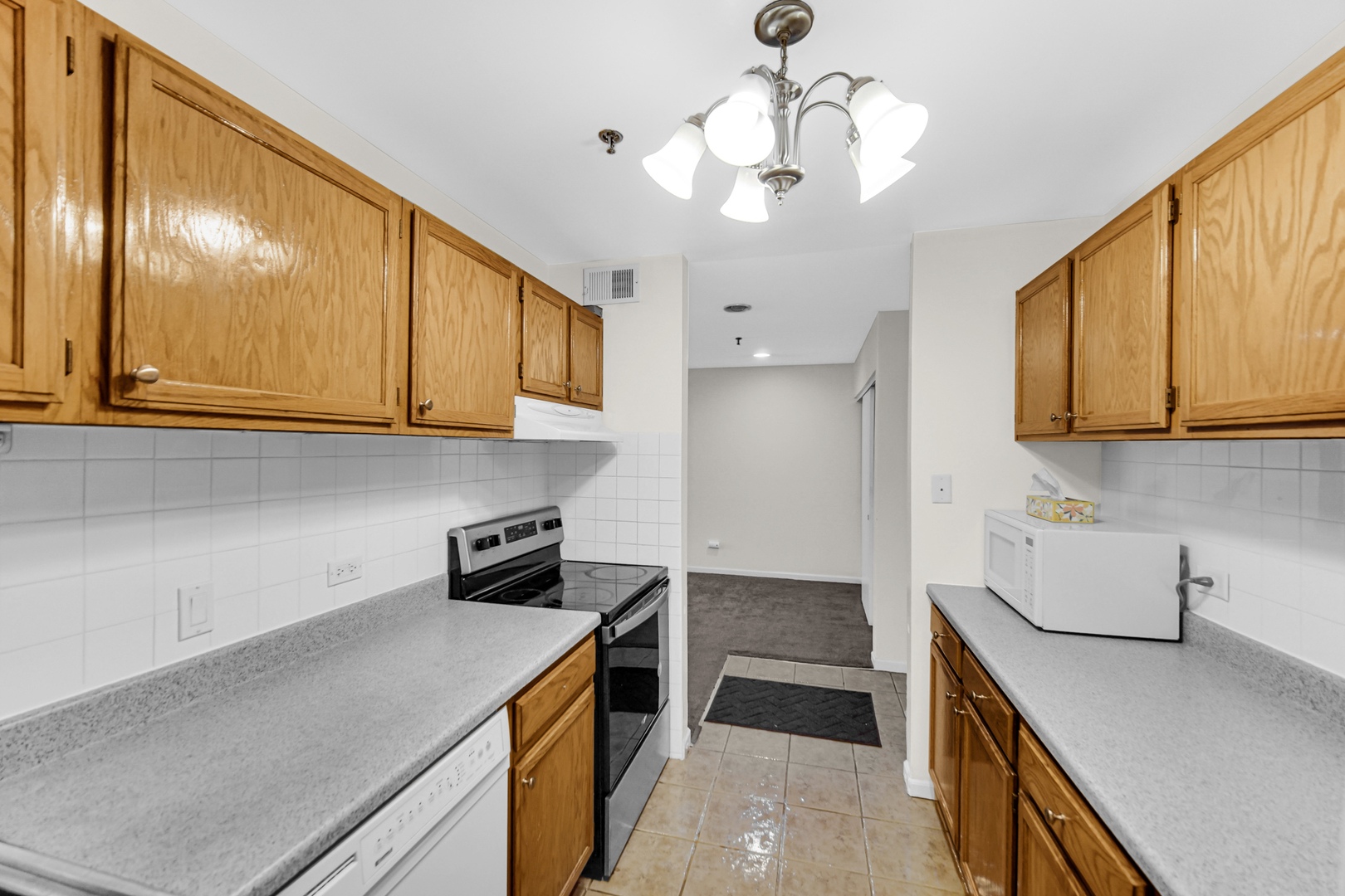 3255 Kirchoff Road, Unit 312 Rolling Meadows, IL 60008 - Photo 8 of 22 a kitchen with stainless steel appliances granite countertop a sink and cabinets