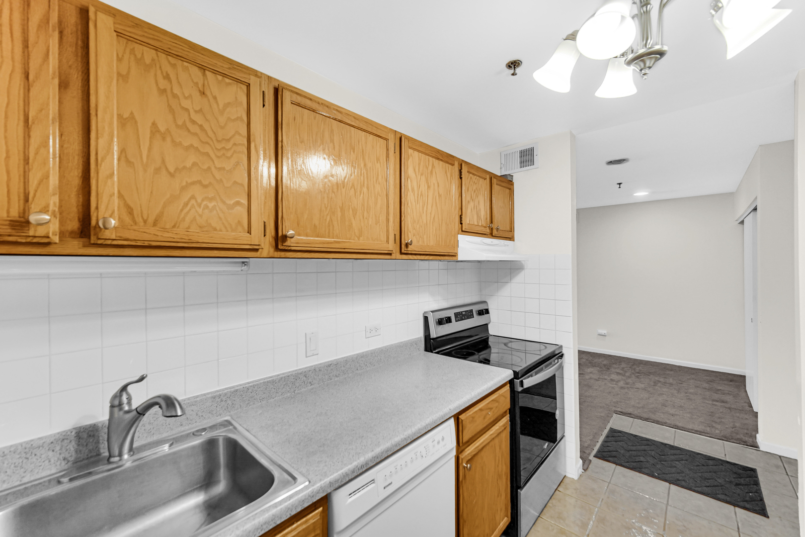 3255 Kirchoff Road, Unit 312 Rolling Meadows, IL 60008 - Photo 9 of 22 a kitchen with stainless steel appliances granite countertop a sink a stove and a microwave oven