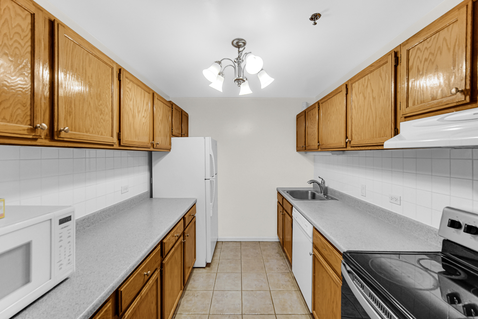 3255 Kirchoff Road, Unit 312 Rolling Meadows, IL 60008 - Photo 10 of 22 a kitchen with stainless steel appliances granite countertop a sink and cabinets