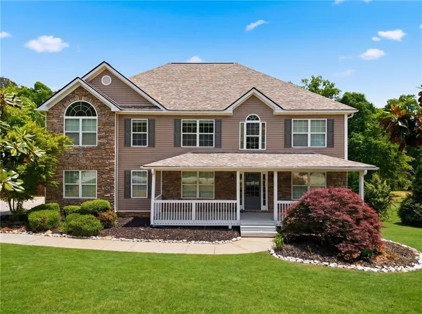 a front view of a house with a yard