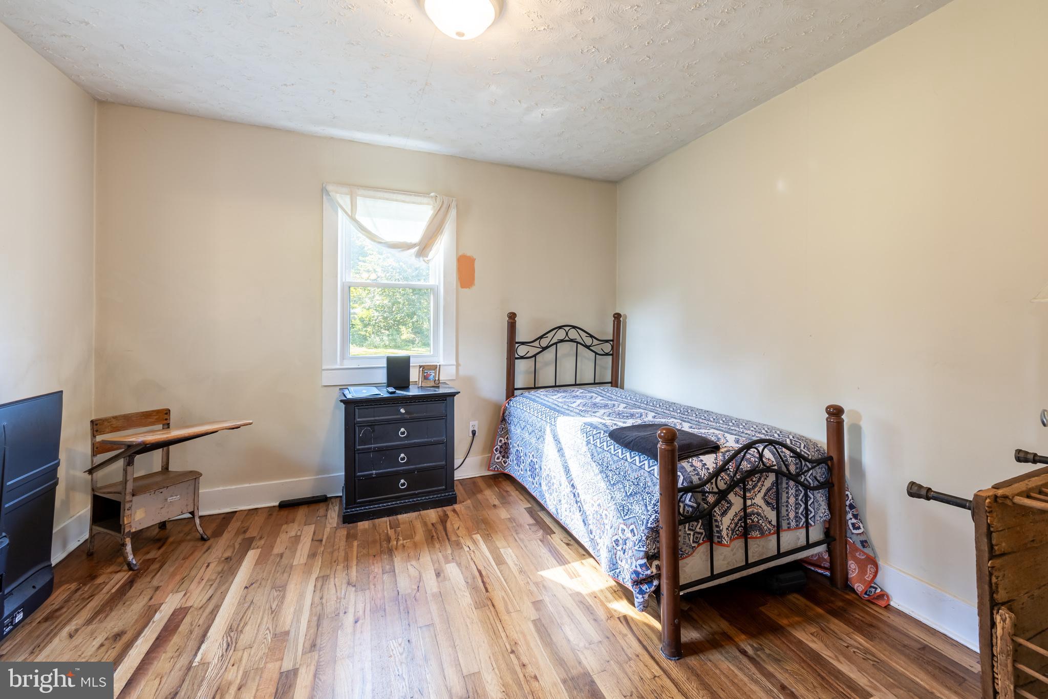 17227 Oakshade Road Orange, VA 22960 - Photo 12 of 19 a bed sitting in a bedroom next to a window