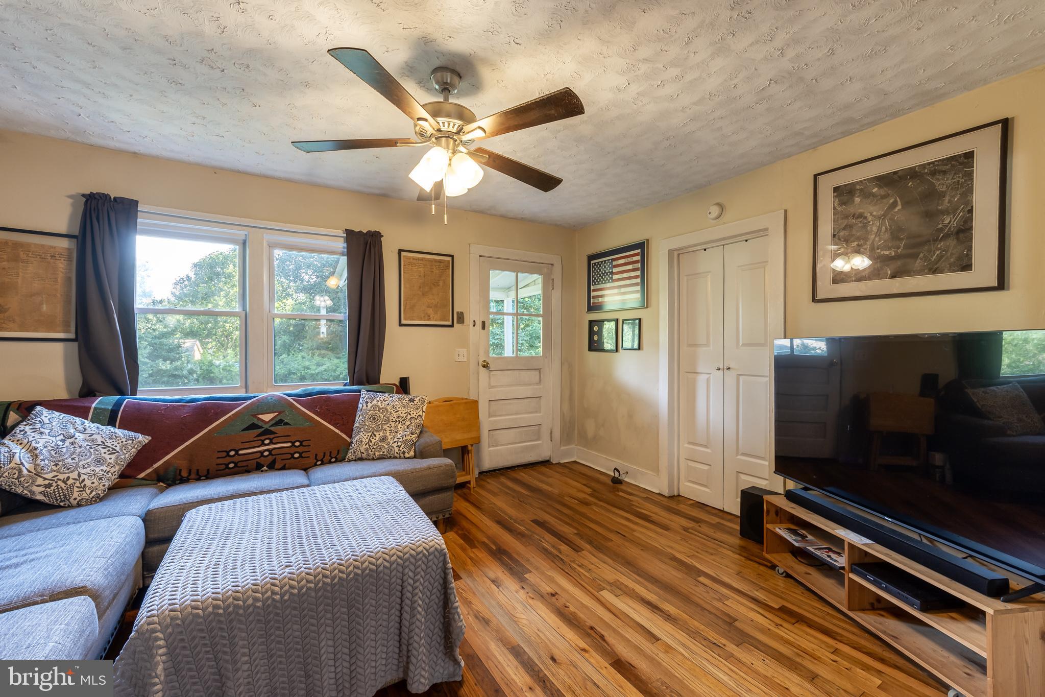 17227 Oakshade Road Orange, VA 22960 - Photo 8 of 19 a living room with a bed furniture and a flat screen tv