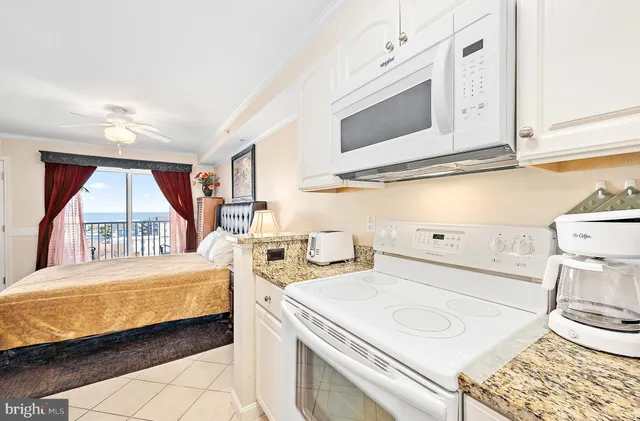 a bedroom with a bed and a flat tv screen next to a window
