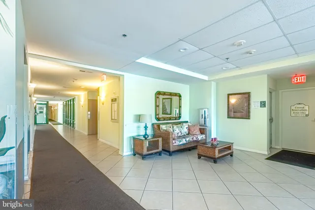 a room with lots of wooden furniture and large windows