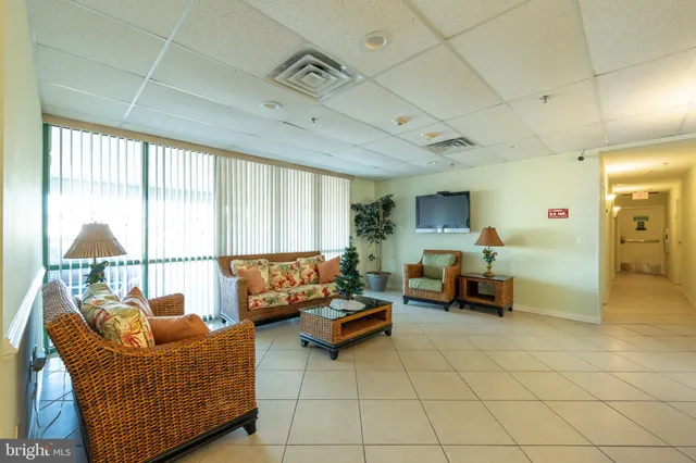 a living room with pool table table and a window