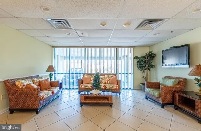 a living room with furniture a table and gym equipment