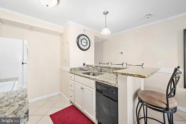 a kitchen with a stove a sink and a refrigerator