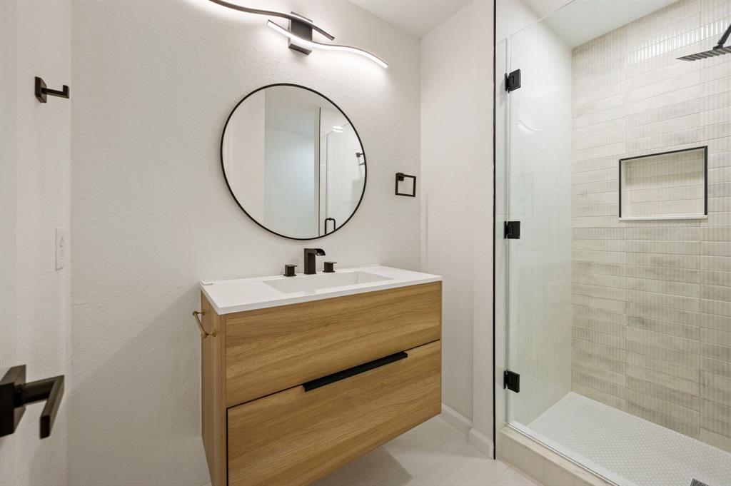5009 Milam Street Dallas, TX 75206 - Photo 23 of 35 Bathroom featuring vanity, a shower stall, and light tile patterned flooring