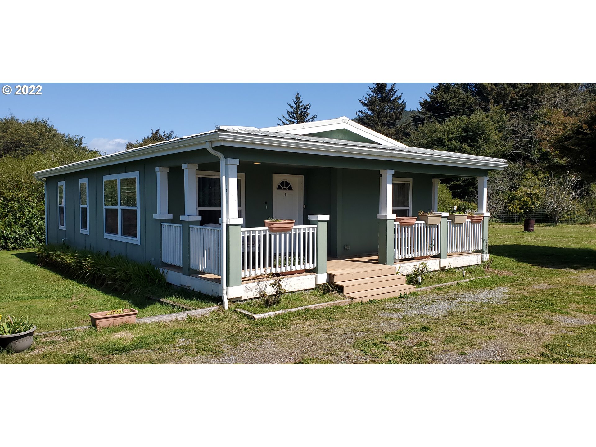 94635 Grange Road Gold Beach, OR 97444 - Photo 1 of 27 a front view of a house with a yard