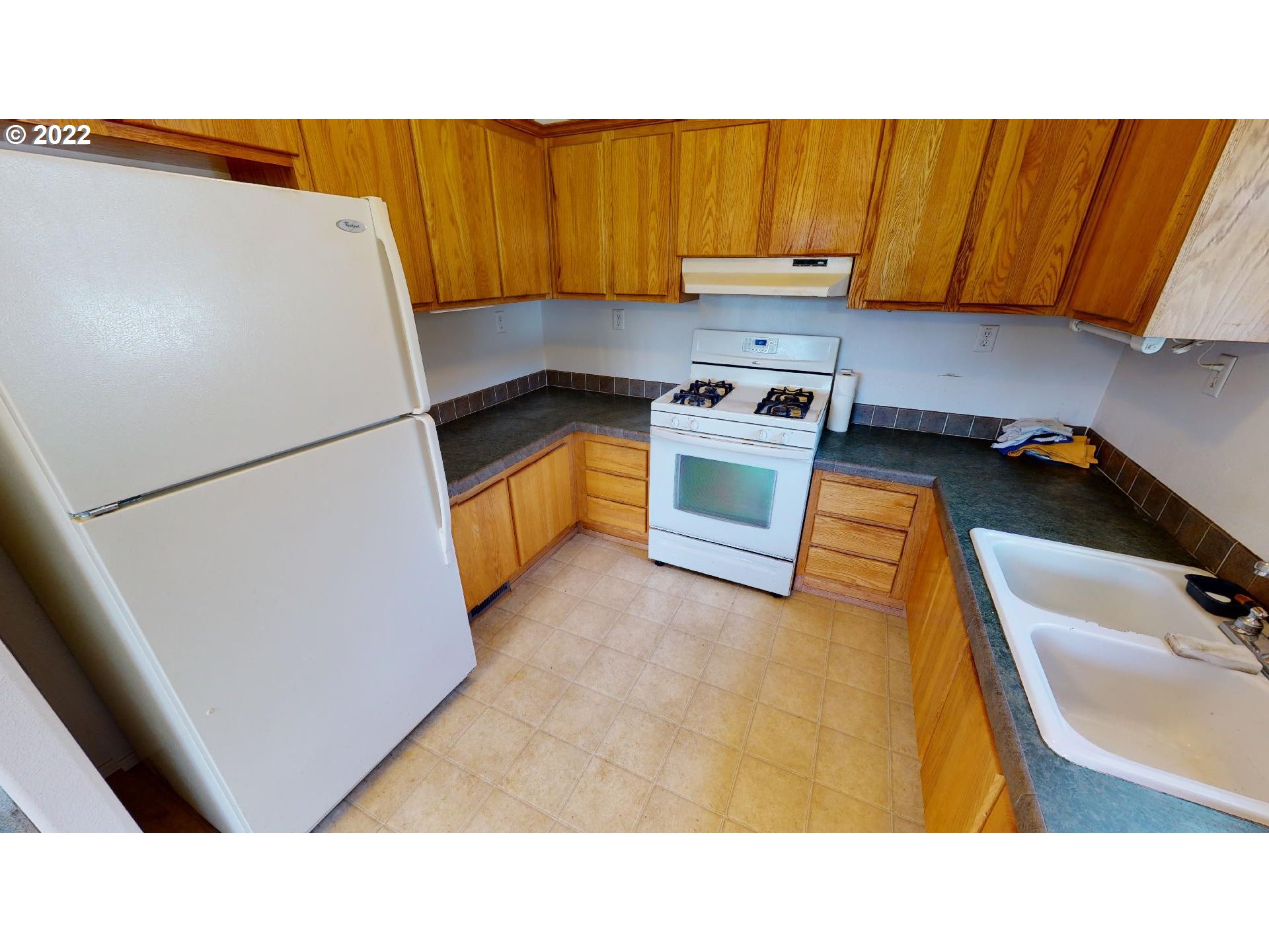 94635 Grange Road Gold Beach, OR 97444 - Photo 12 of 27 a kitchen with a refrigerator and a sink
