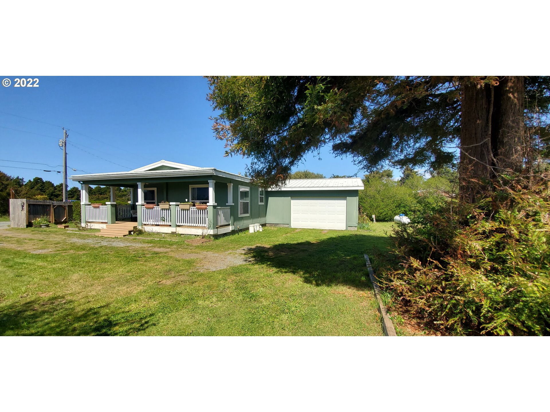 94635 Grange Road Gold Beach, OR 97444 - Photo 2 of 27 a view of a house with garden