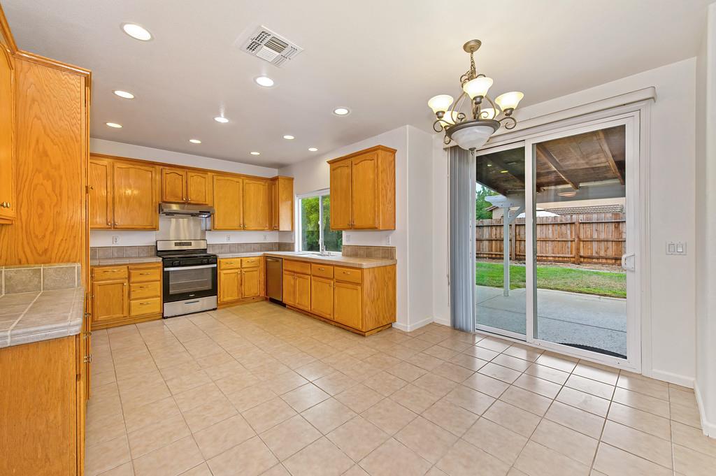 3524 Riojo Way Rancho Cordova, CA 95670 - Photo 13 of 47 a kitchen with stainless steel appliances a stove a sink and a refrigerator