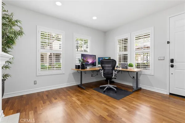 a view of a livingroom with workspace and windows