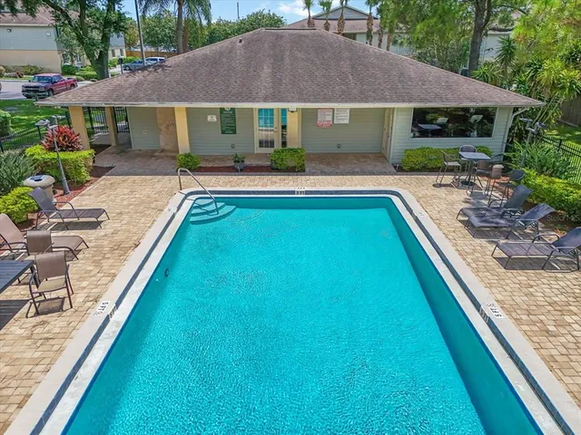 a house with swimming pool in front of it