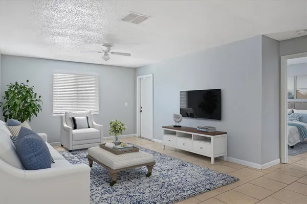 a living room with furniture and a flat screen tv