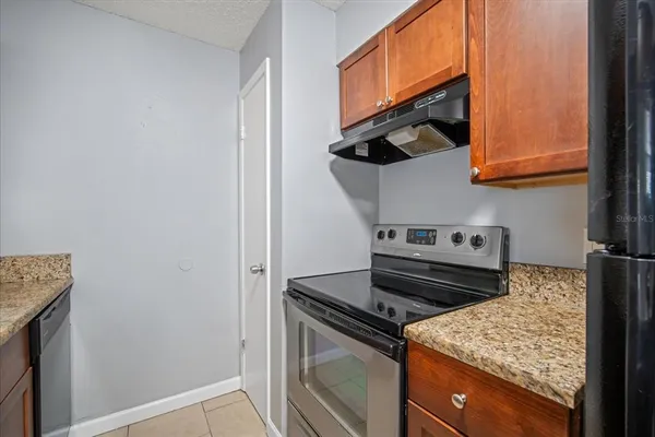 a stove top oven sitting inside of a kitchen