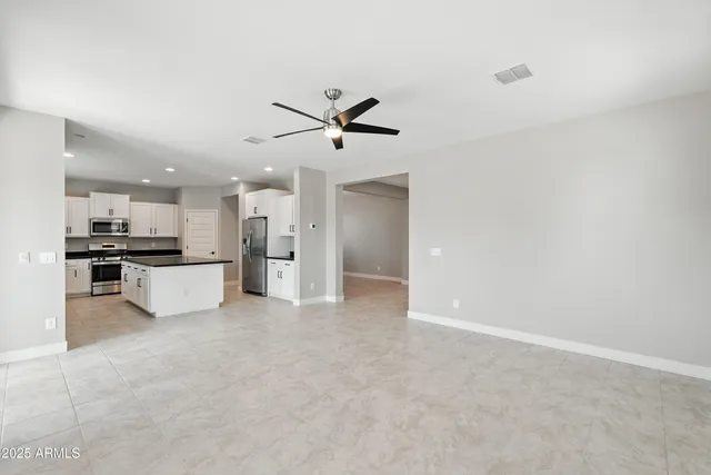 a view of an empty room with a kitchen