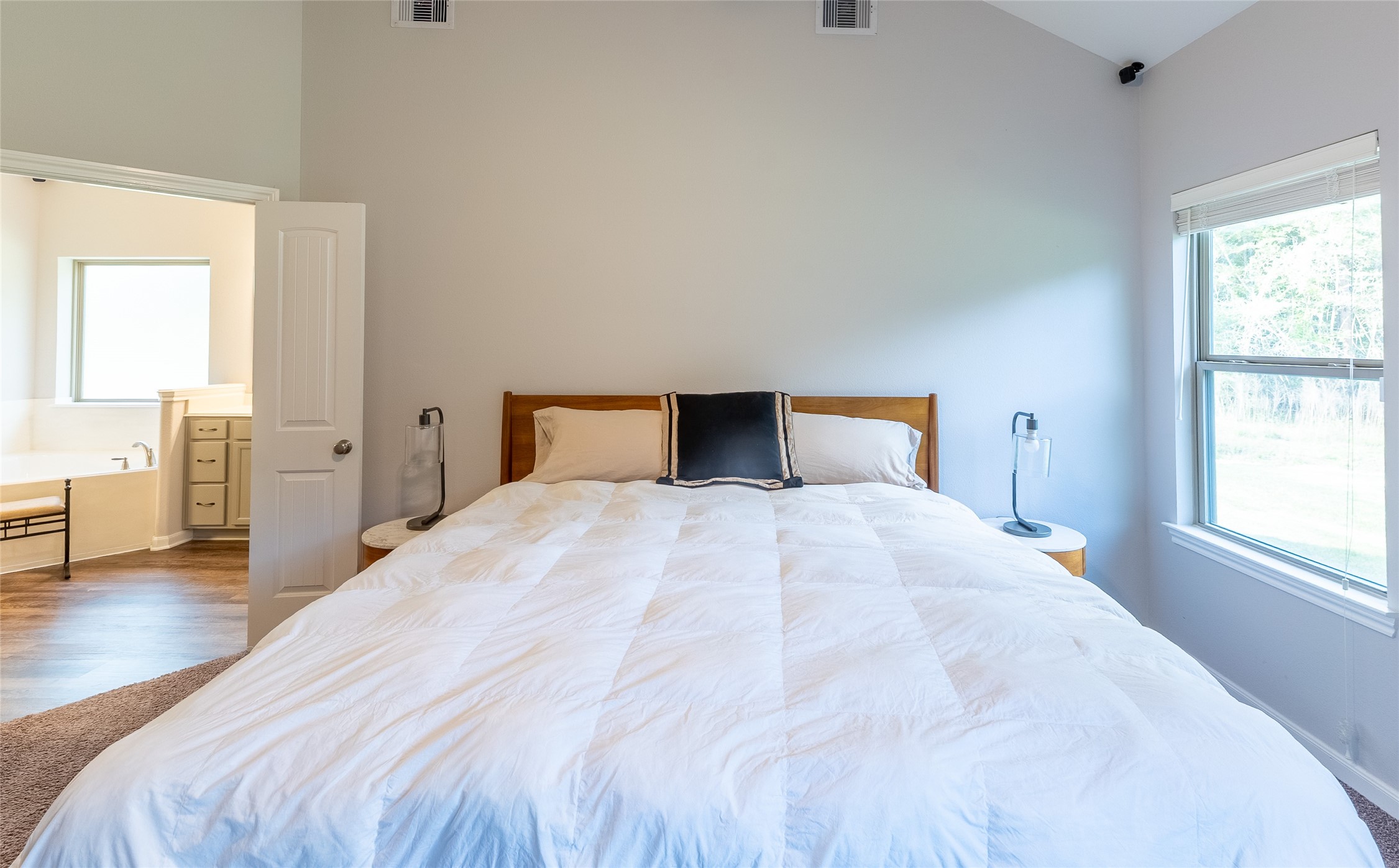 120 Sanctuary Road Huntsville, TX 77340 - Photo 22 of 38 a bedroom with a bed and wooden floor