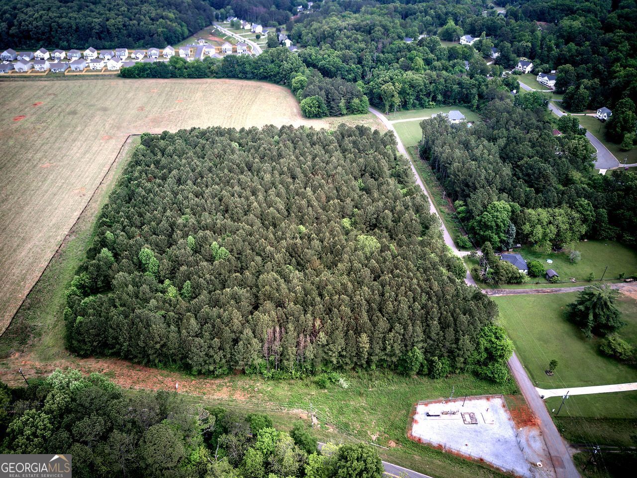 720 Euharlee Road Cartersville, GA 30120 - Photo 4 of 13 a view of a garden with a bench and trees in the background