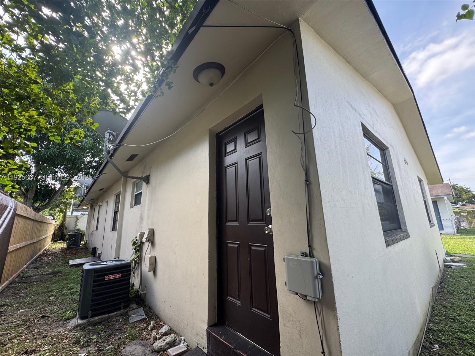 6134 Southwest 40th Court Miramar, FL 33023 - Photo 6 of 15 a view of a house with a door and wooden fence