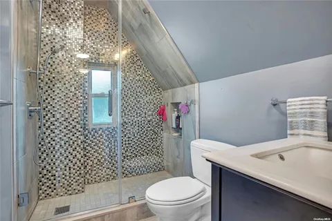 a bathroom with a toilet and shower