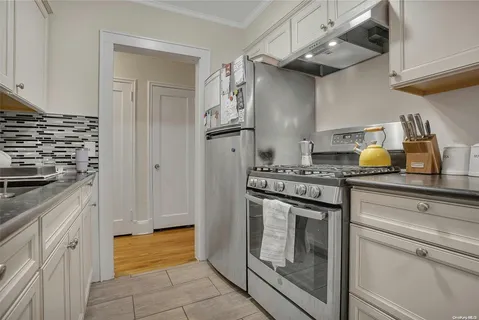 a kitchen with stainless steel appliances granite countertop a stove and a refrigerator