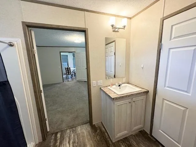 a kitchen with kitchen island a dining table chairs stainless steel appliances and cabinets