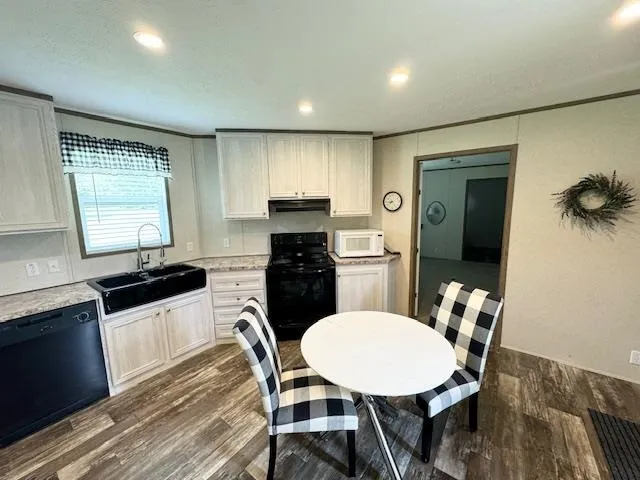 an empty room with window and a refrigerator