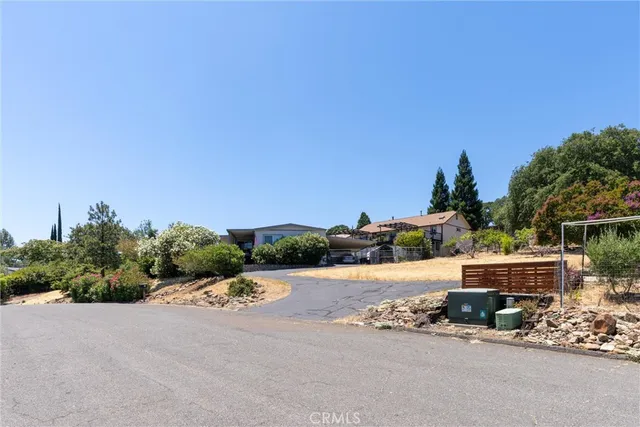 a backyard of a house with wooden fence and trees