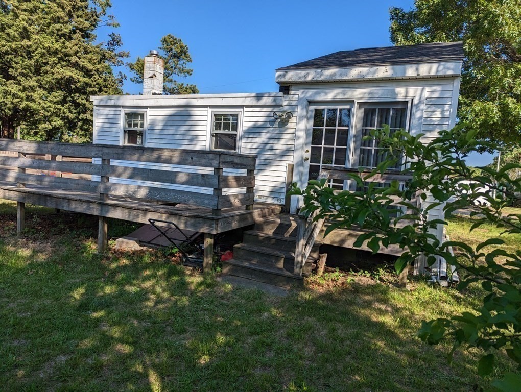 12 Howard Street Wareham, MA 02571 - Photo 2 of 11 a view of a house with a wooden deck and a lake view
