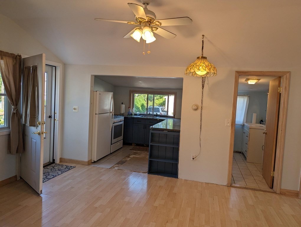 12 Howard Street Wareham, MA 02571 - Photo 4 of 11 an empty room with wooden floor cabinet and windows