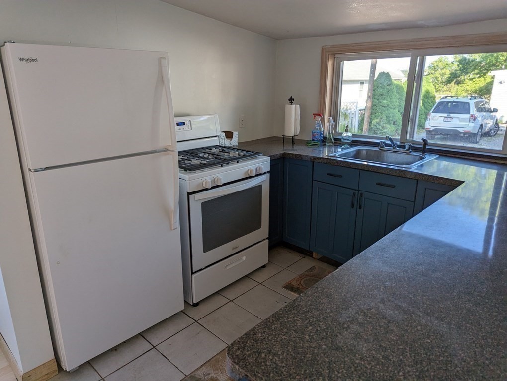 12 Howard Street Wareham, MA 02571 - Photo 5 of 11 a kitchen with a refrigerator and a sink