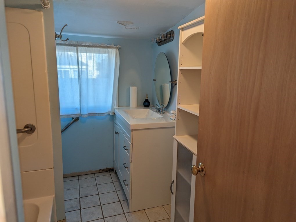 12 Howard Street Wareham, MA 02571 - Photo 9 of 11 a bathroom with a sink toilet and shower