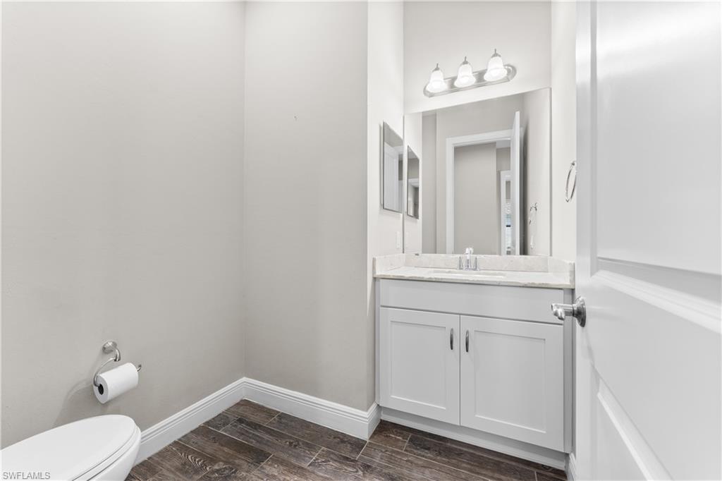 4711 Abaca Circle Naples, FL 34119 - Photo 14 of 32 a bathroom with a sink and mirror