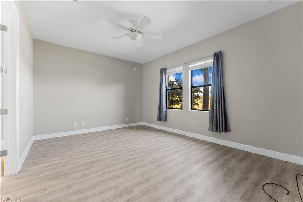 4711 Abaca Circle Naples, FL 34119 - Photo 15 of 32 wooden floor in an empty room with a window
