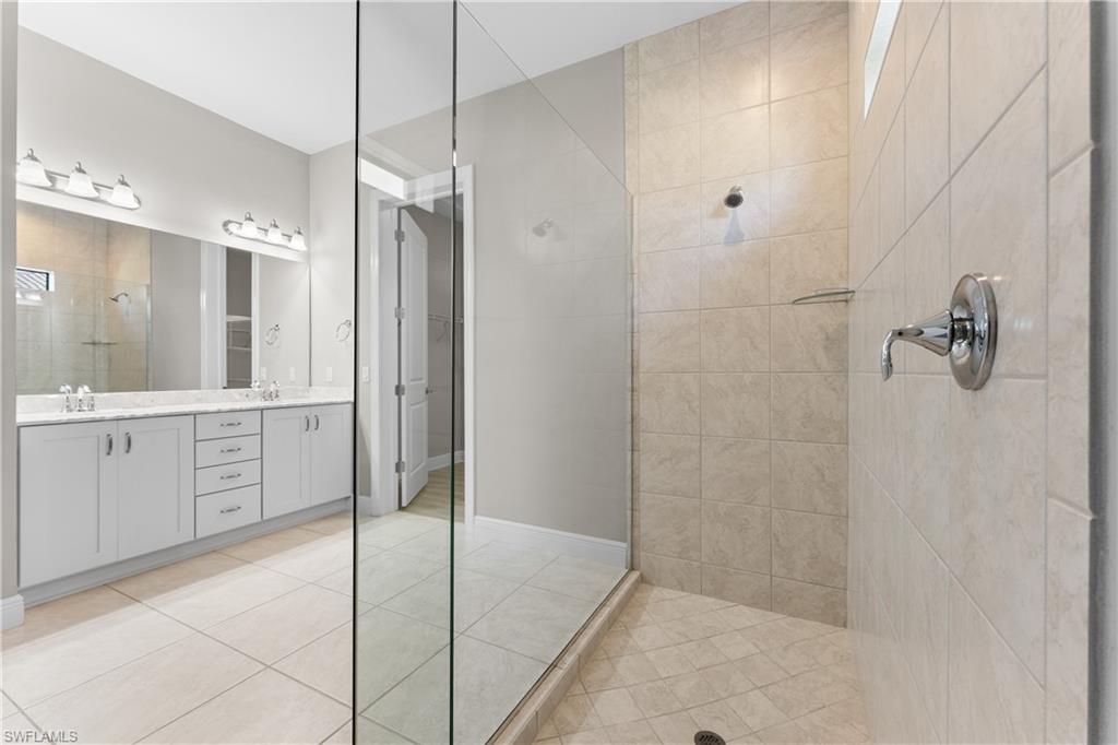 4711 Abaca Circle Naples, FL 34119 - Photo 18 of 32 a bathroom with a shower and a sink
