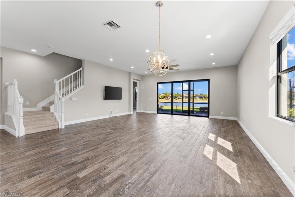 4711 Abaca Circle Naples, FL 34119 - Photo 2 of 32 a view of an empty room with wooden floor and a window