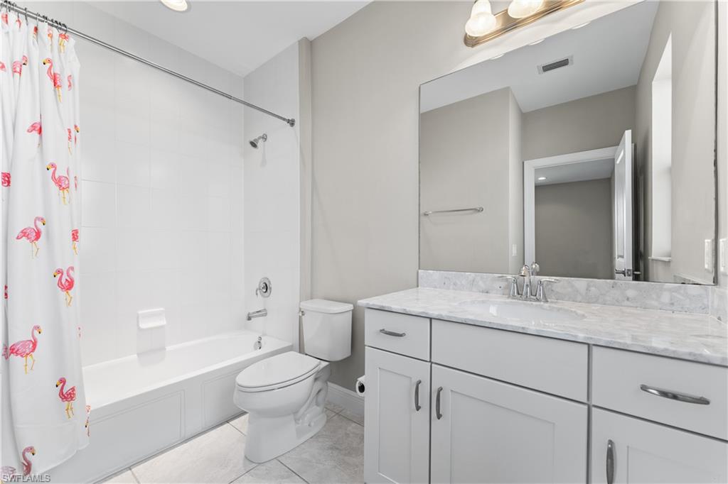 4711 Abaca Circle Naples, FL 34119 - Photo 24 of 32 a bathroom with a sink a toilet and a bathtub