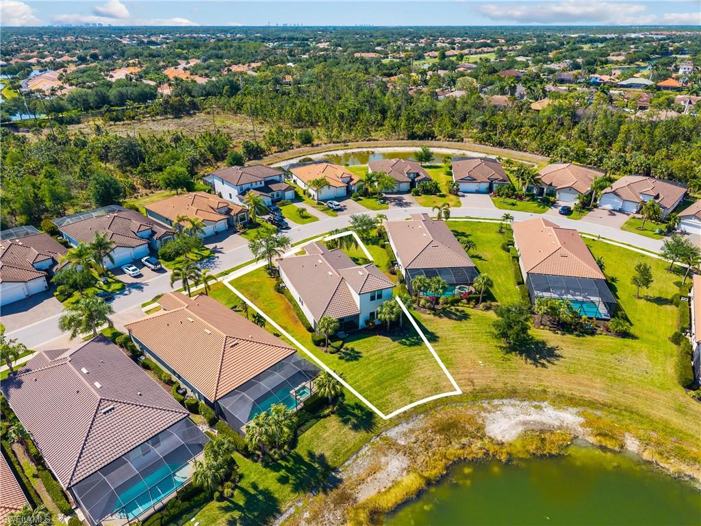 4711 Abaca Circle Naples, FL 34119 - Photo 27 of 32 an aerial view of a house with a swimming pool yard and outdoor seating