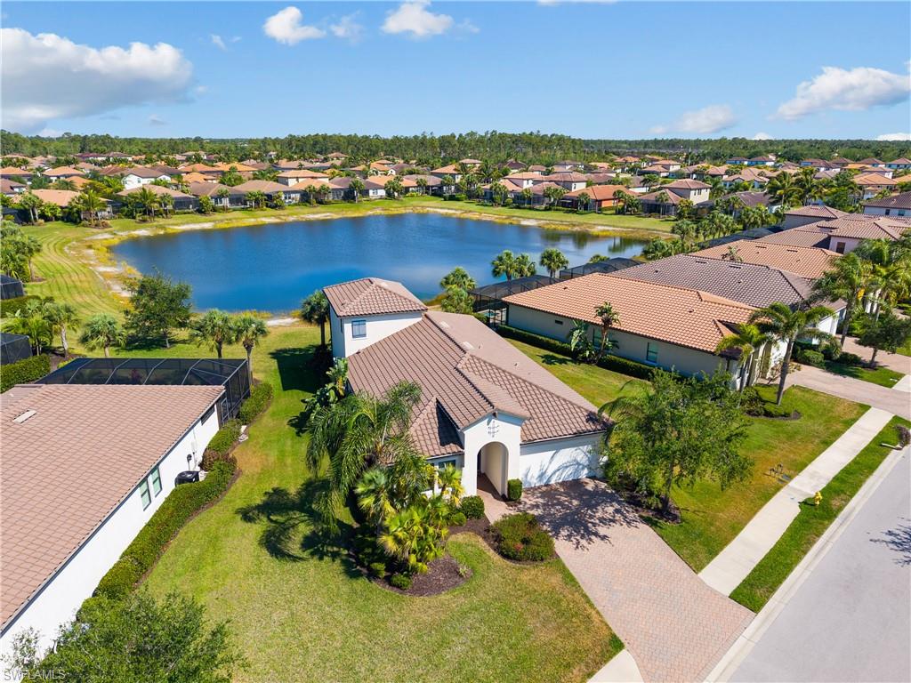 4711 Abaca Circle Naples, FL 34119 - Photo 28 of 32 an aerial view of a house with a lake view