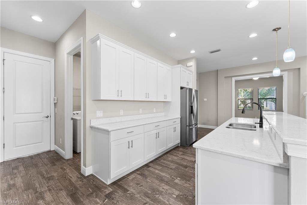 4711 Abaca Circle Naples, FL 34119 - Photo 10 of 32 a kitchen with a sink and refrigerator