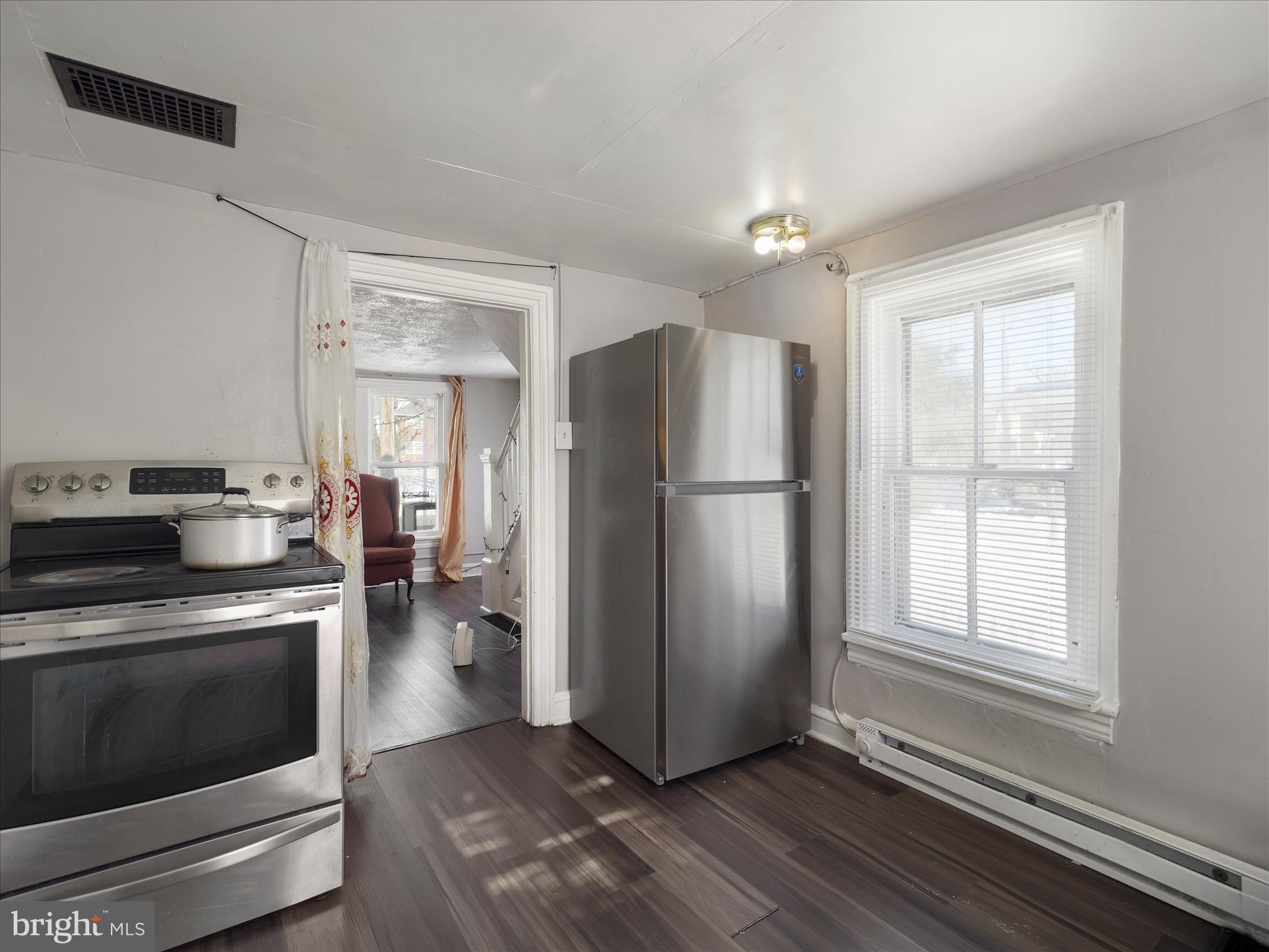 810 Broad Street Chambersburg, PA 17201 - Photo 12 of 16 a kitchen with a refrigerator a stove top oven and cabinets