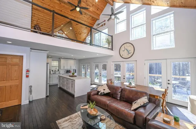 a living room with furniture a wooden floor and a clock