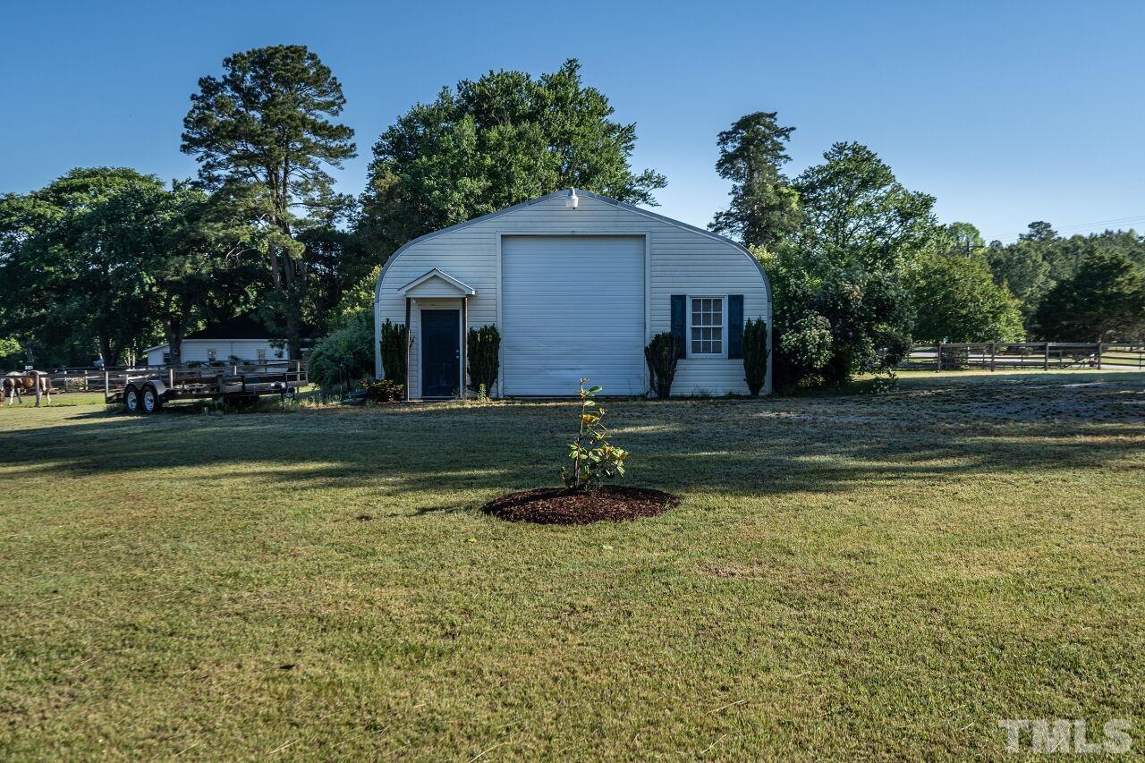 4131 Pearces Road Zebulon, NC 27597 - Photo 31 of 31 a view of a house with a yard