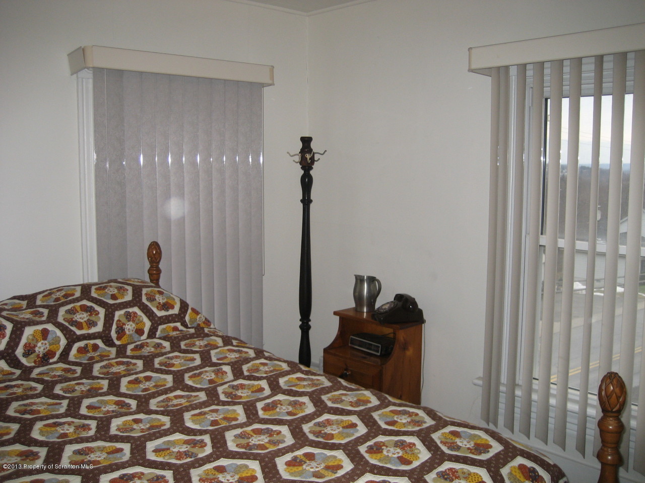 99 Jefferson Street Simpson, PA 18407 - Photo 11 of 16 a bedroom with a bed and a chair