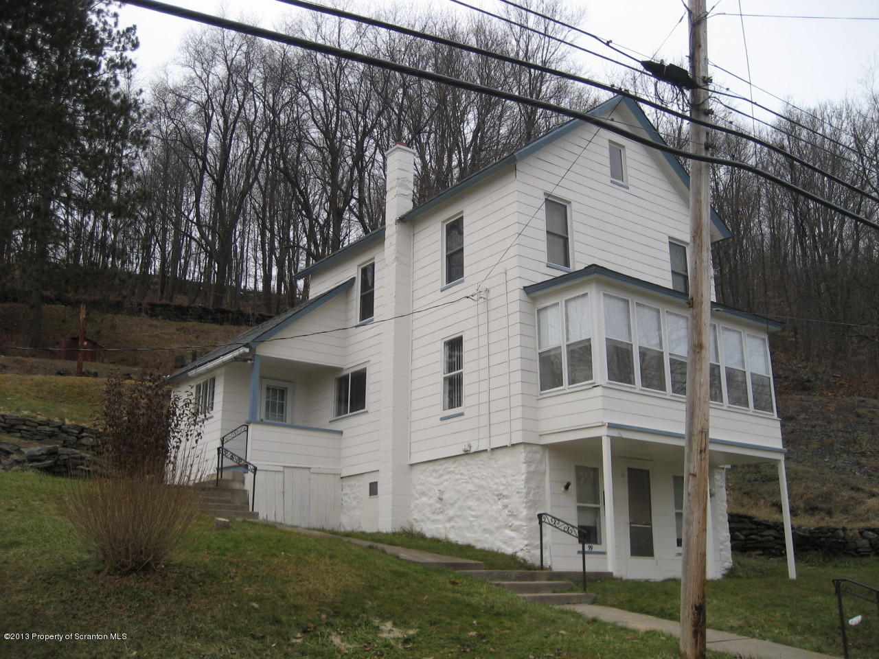 99 Jefferson Street Simpson, PA 18407 - Photo 2 of 16 a view of a white house with large windows