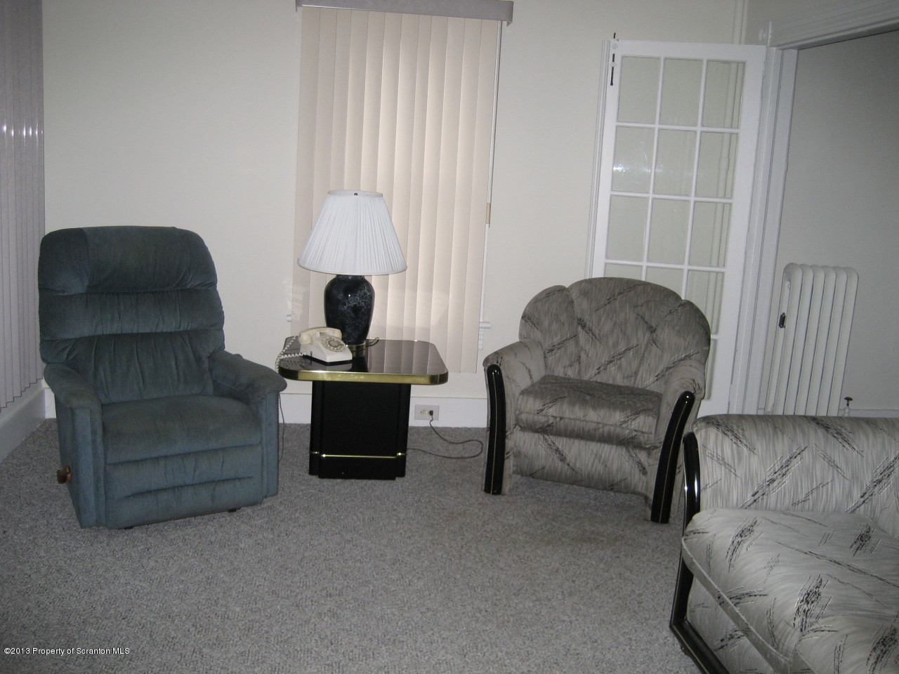 99 Jefferson Street Simpson, PA 18407 - Photo 7 of 16 a living room with furniture and a fireplace