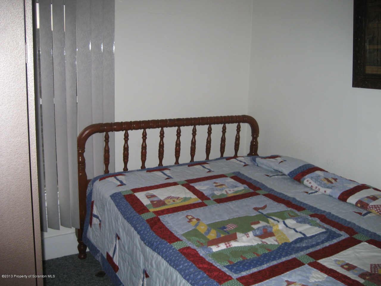 99 Jefferson Street Simpson, PA 18407 - Photo 8 of 16 a bed sitting in a bedroom next to a window