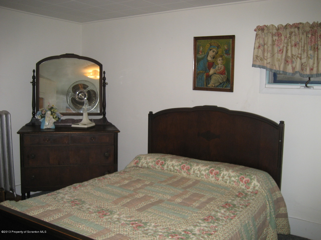 99 Jefferson Street Simpson, PA 18407 - Photo 9 of 16 a bedroom with a bed and a dresser